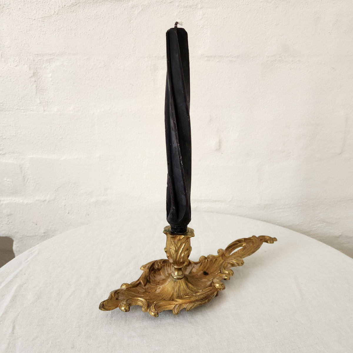 antique brass chamber candlestick with black candle