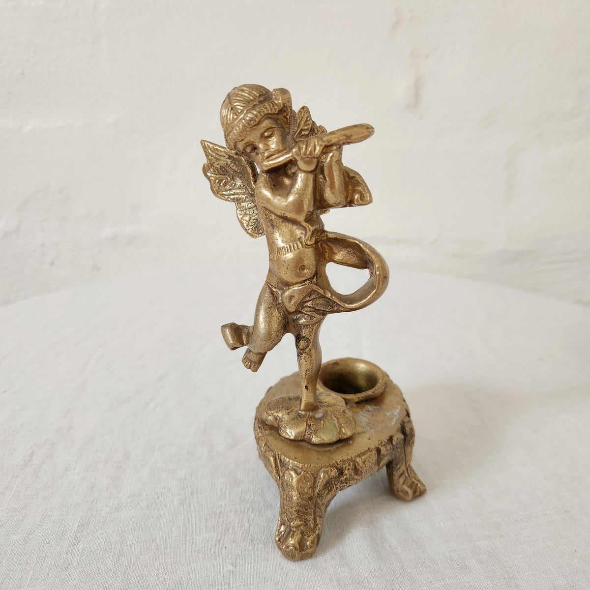 Antique brass cherub form candlestick