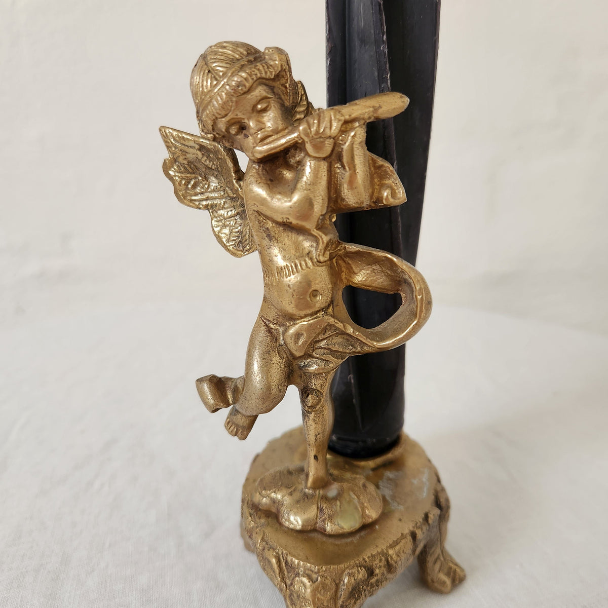 Antique brass cherub form candlestick