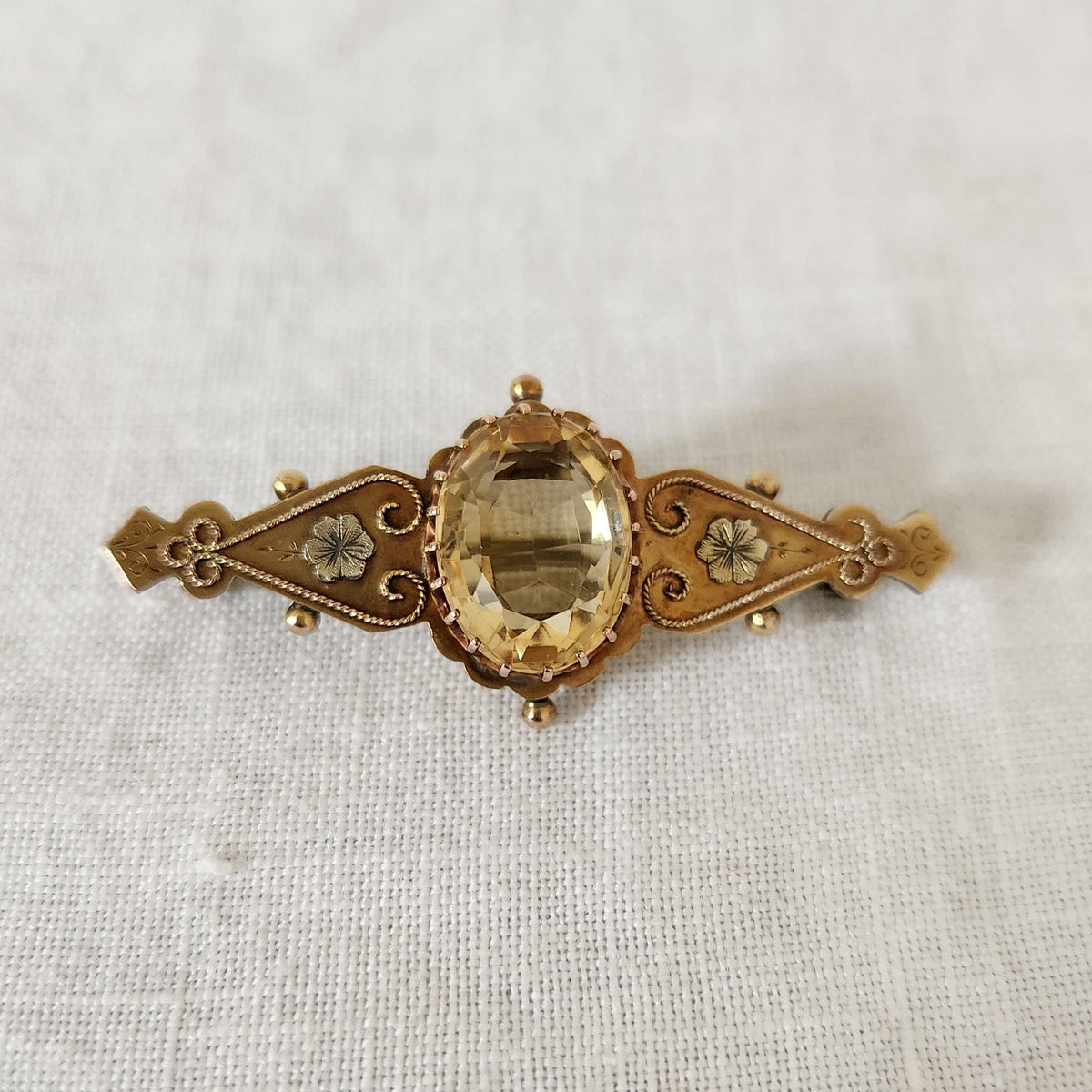 Antique Citrine Brooch on linen fabric background
