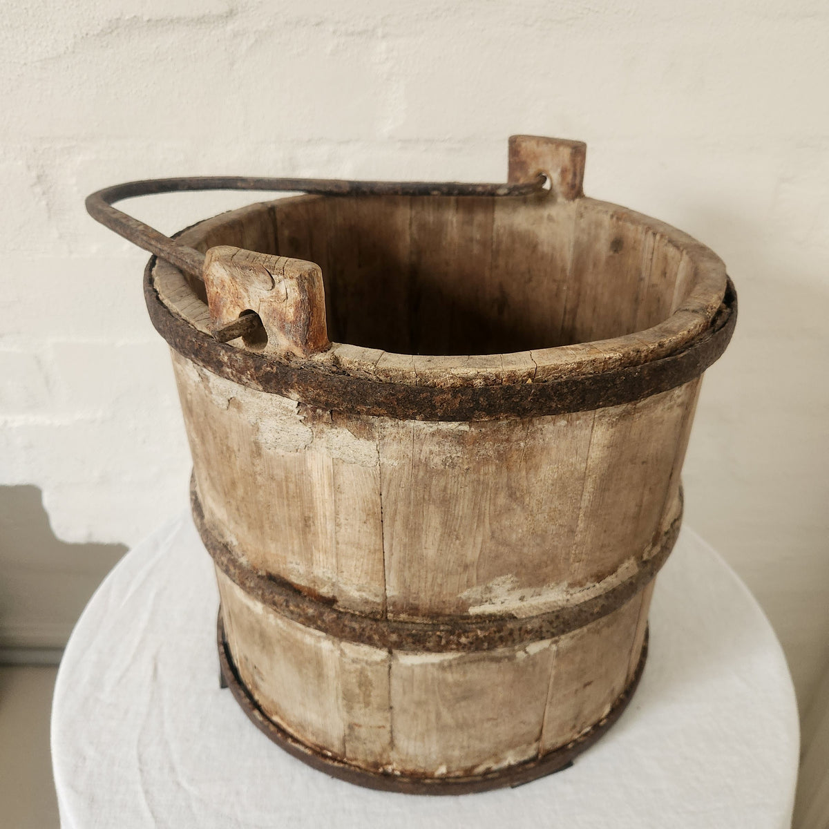 Vintage wooden bucket with iron handle