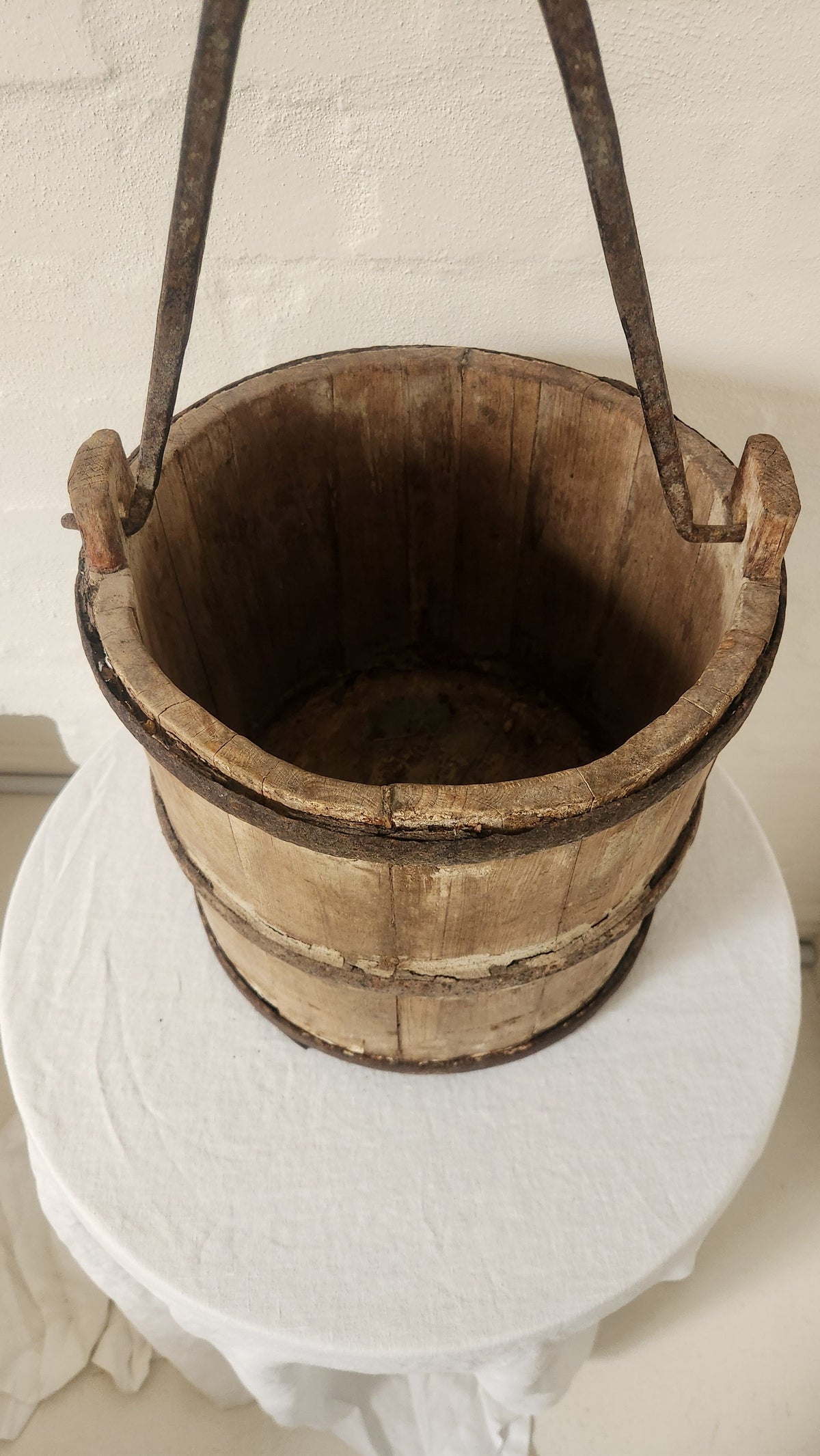Vintage wooden bucket with iron handle