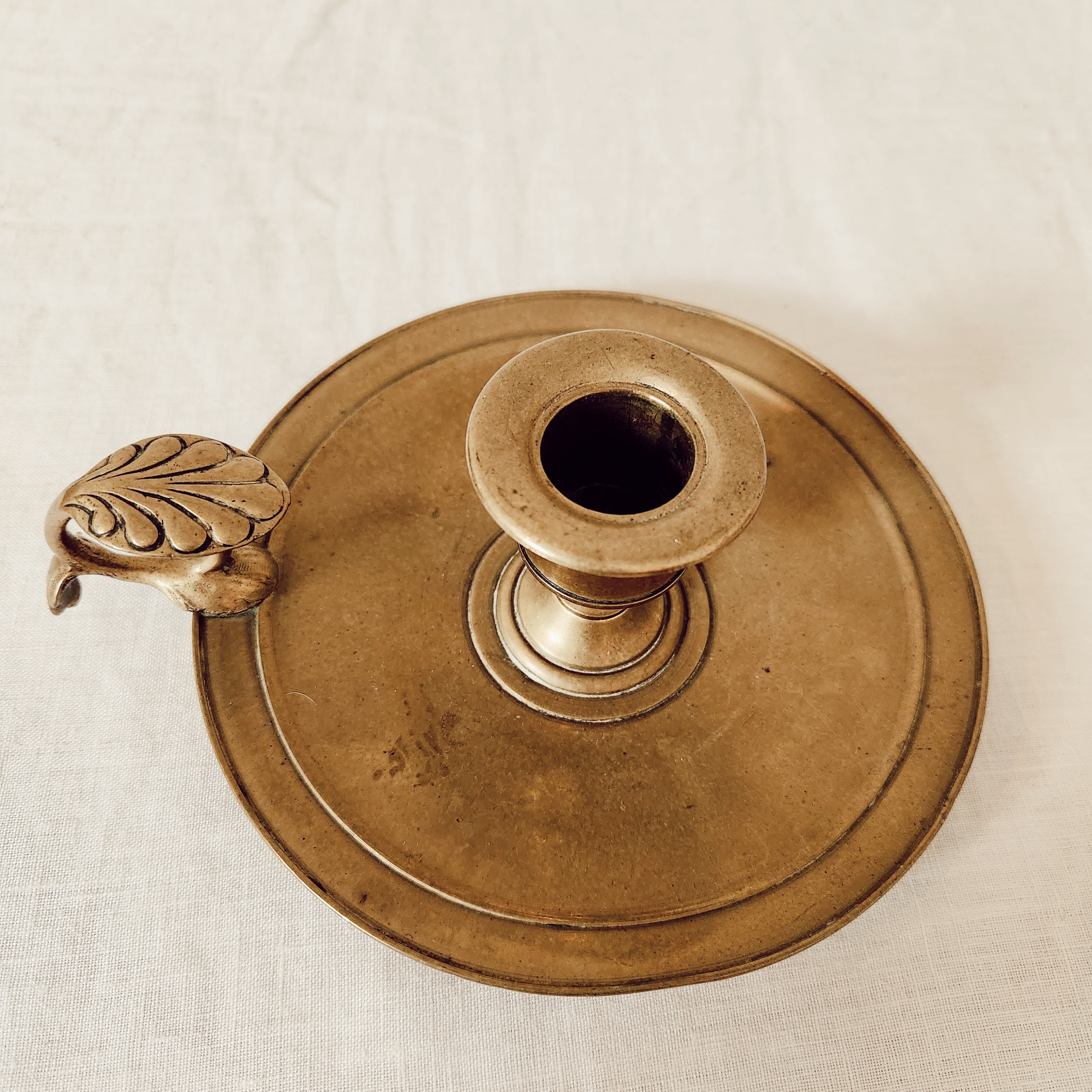 Antique brass chamberstick with decorative handle