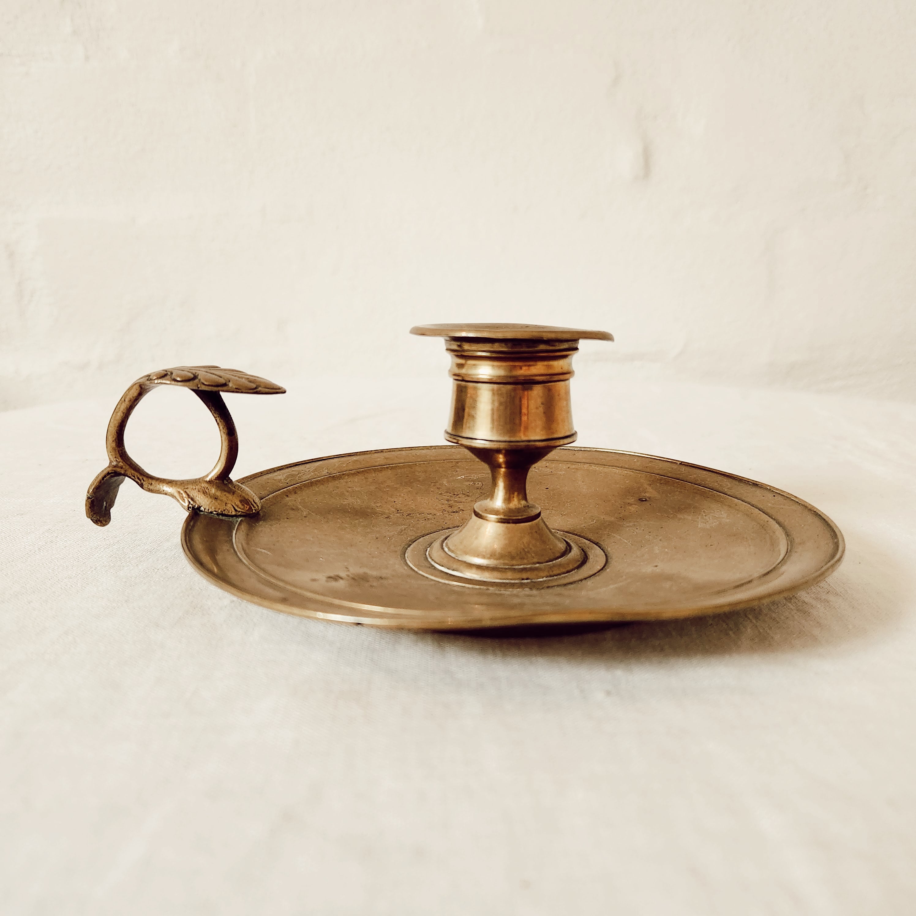 Antique brass chamberstick with decorative handle