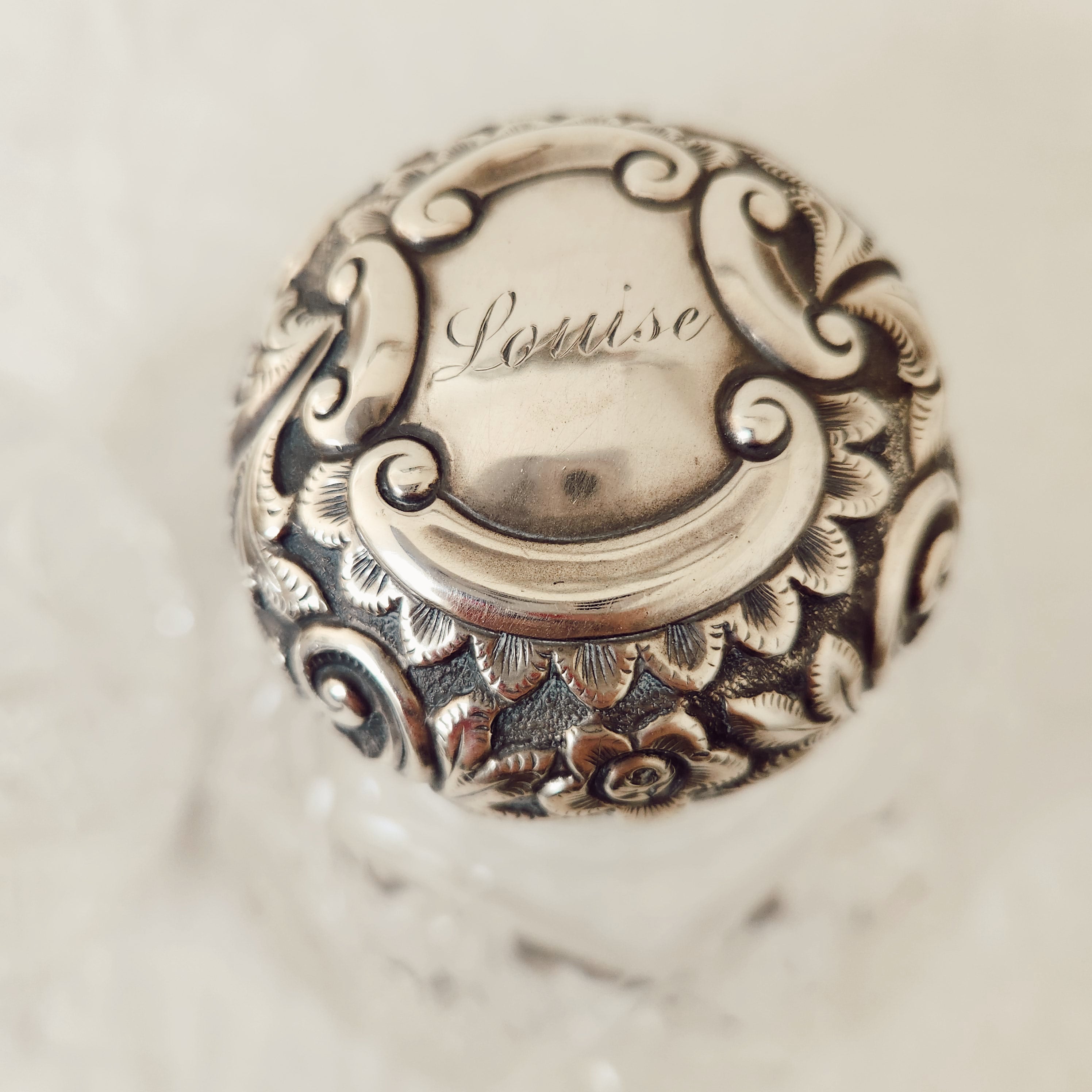 A Vintage Pair of Profusely Cut-Glass Perfume Bottles with silver plated stoppers and ‘Louise’ Engraved on the lids.