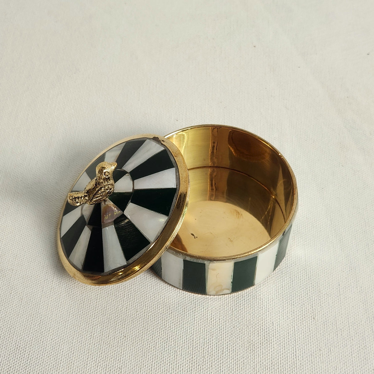 inside of Green striped small brass box