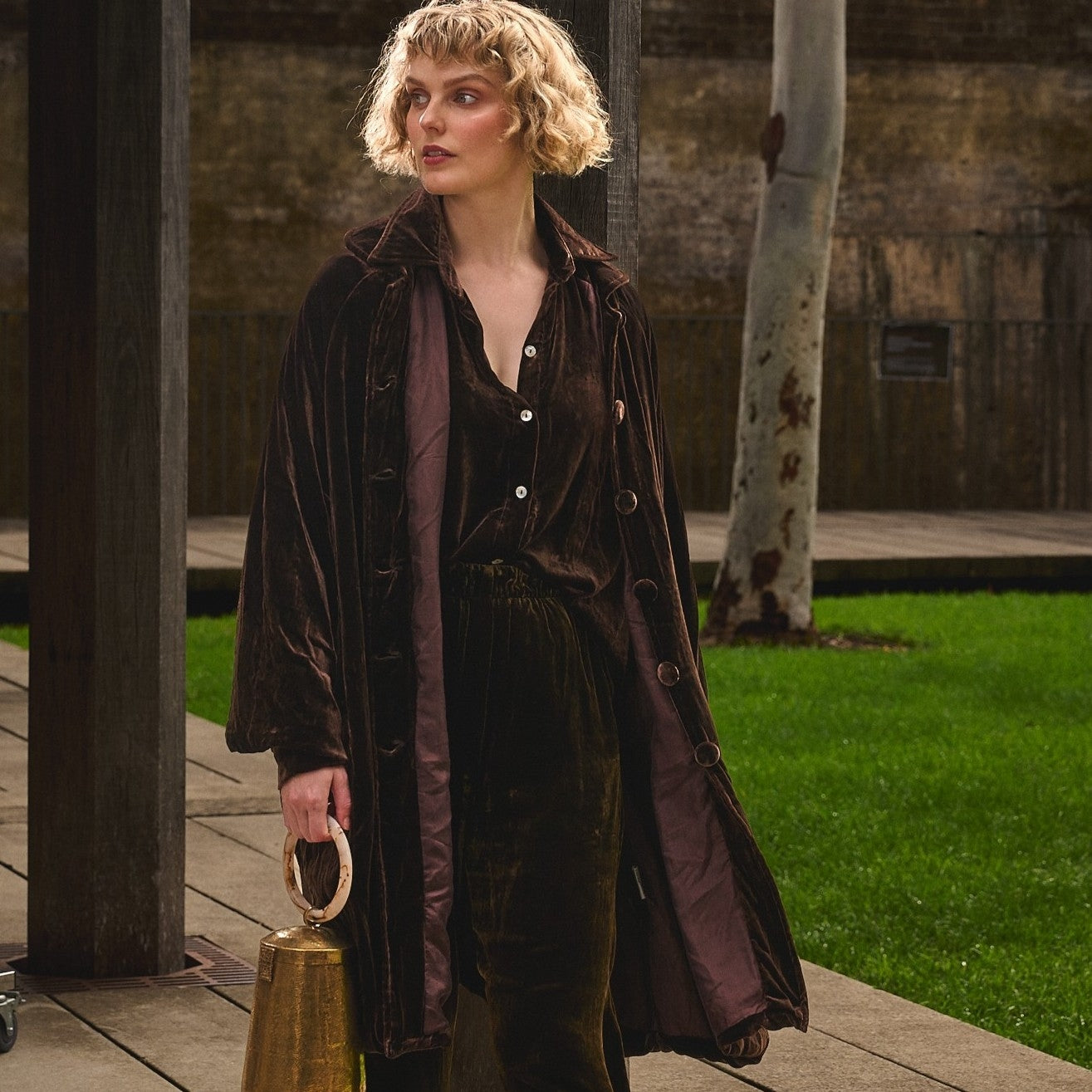 woman in chocolate silk velvet coat