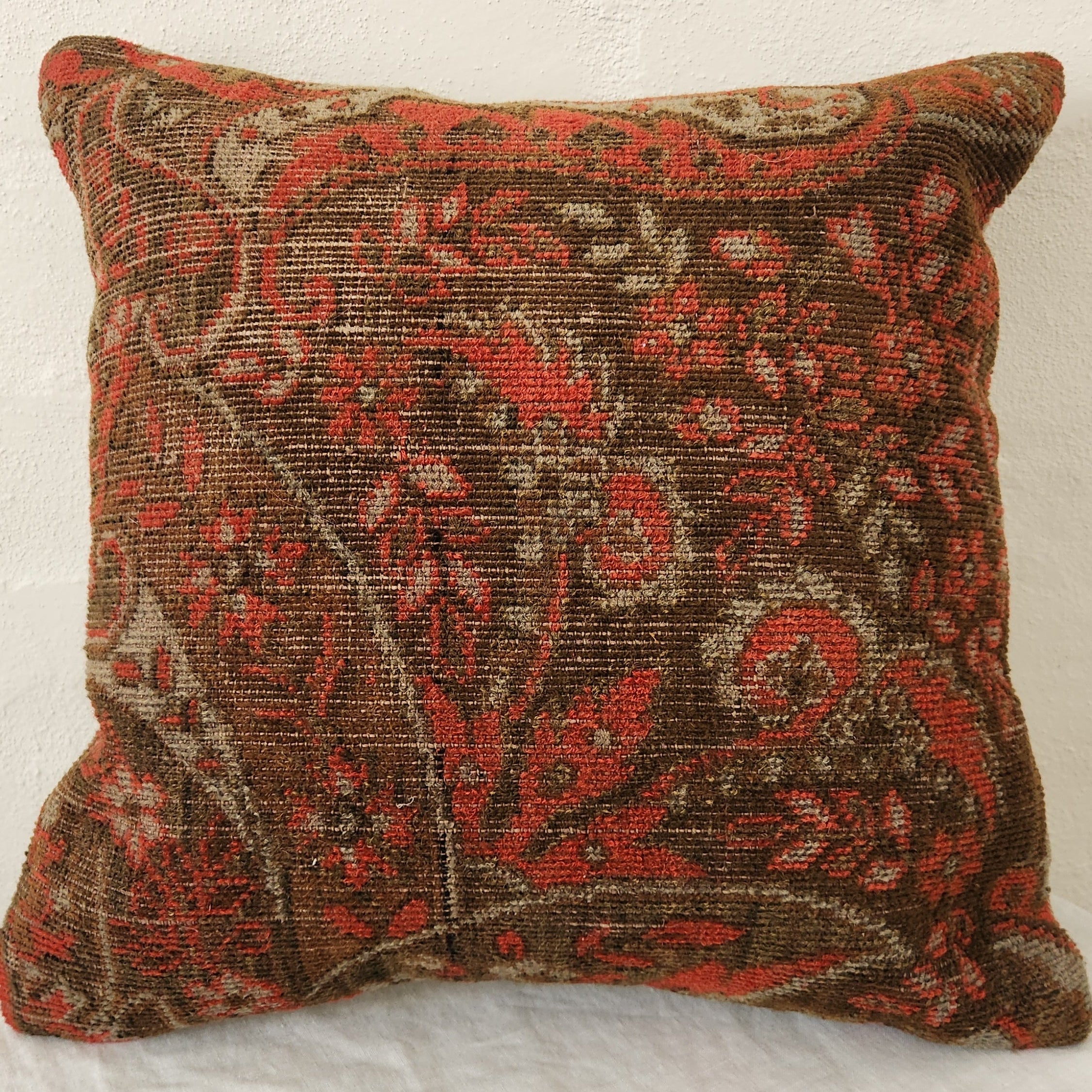 Decorative Kilim pillow with intricate patterns on a textured surface