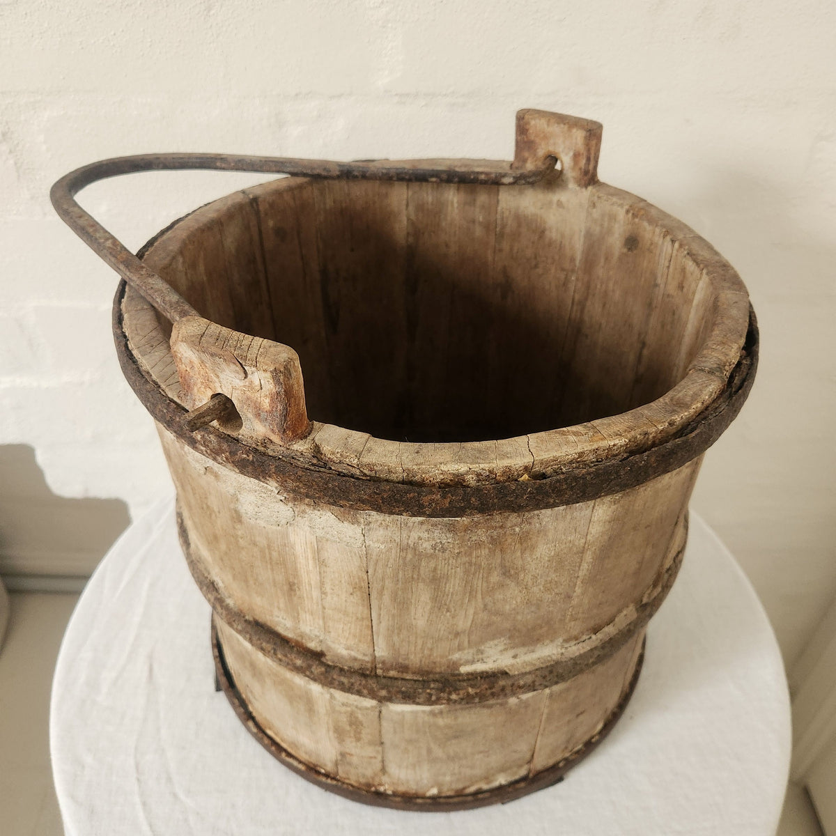 Vintage wooden bucket with iron handle