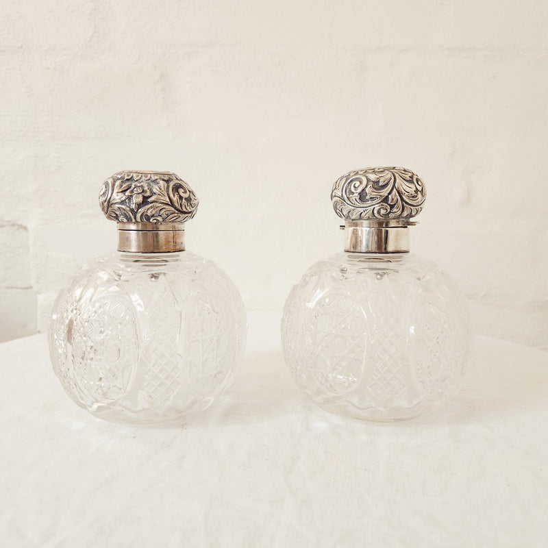 A Vintage Pair of Profusely Cut-Glass Perfume Bottles with silver plated stoppers and ‘Louise’ Engraved on the lids.