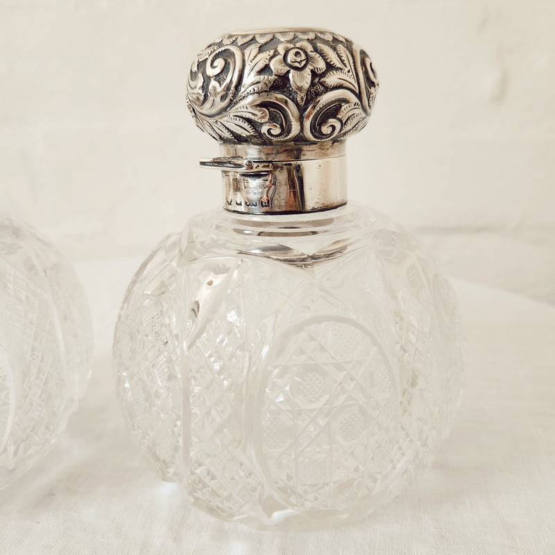 A Vintage Pair of Profusely Cut-Glass Perfume Bottles with silver plated stoppers and ‘Louise’ Engraved on the lids.