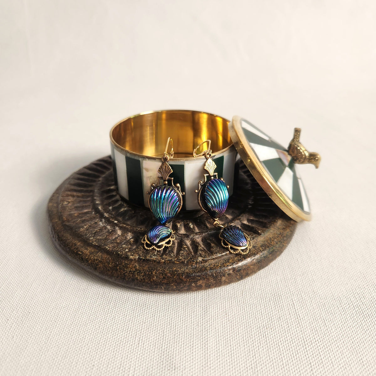 Green striped small brass box with blu earrings
