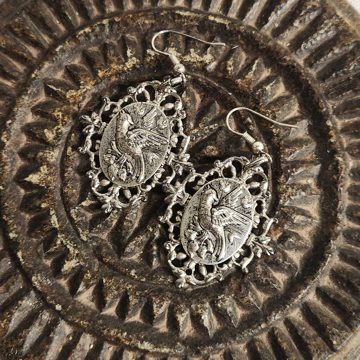 Antique cameo silver ear rings on dark background