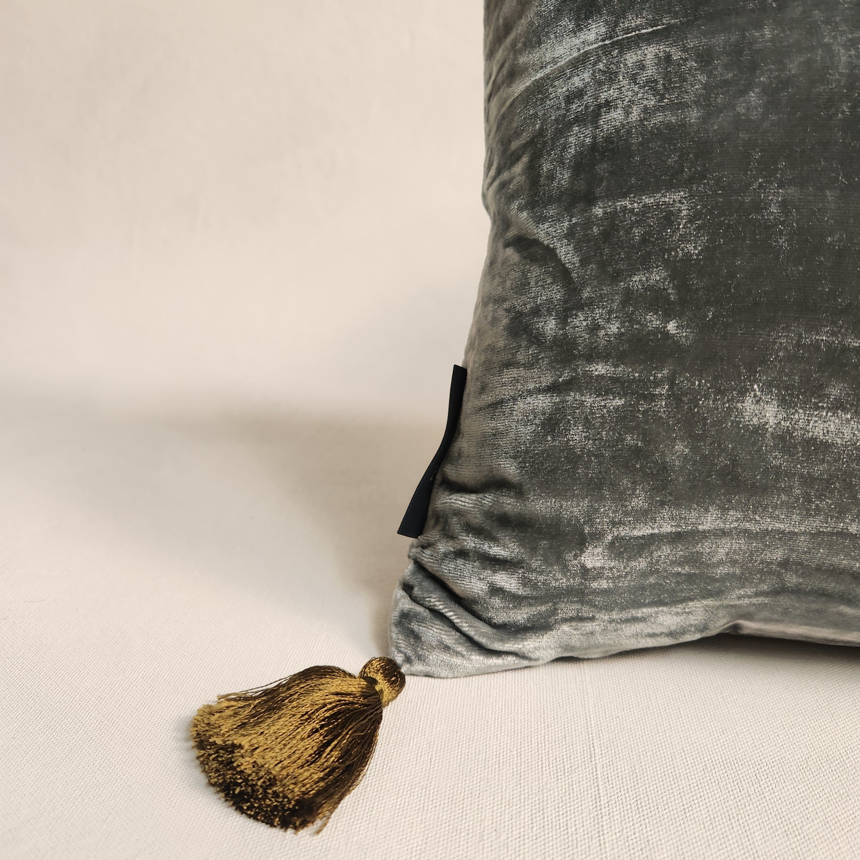 Blue green silk velvet pillow with contrasting tassels.