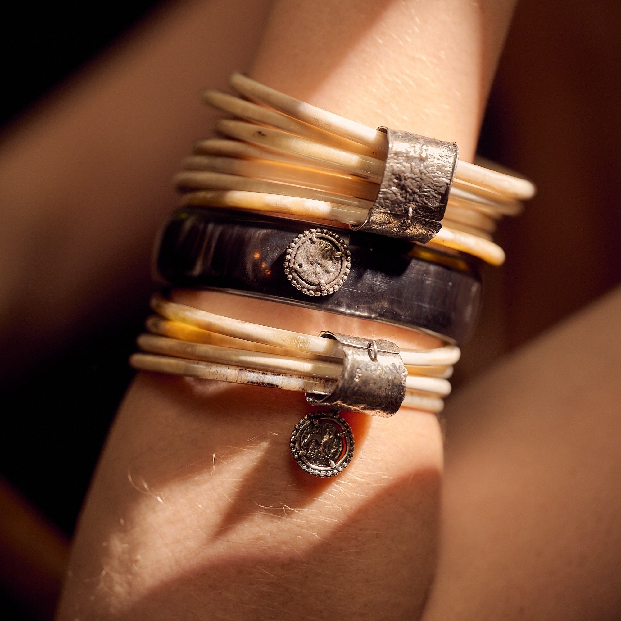 Single Black Buffalo Bangle with three silver plated coins.