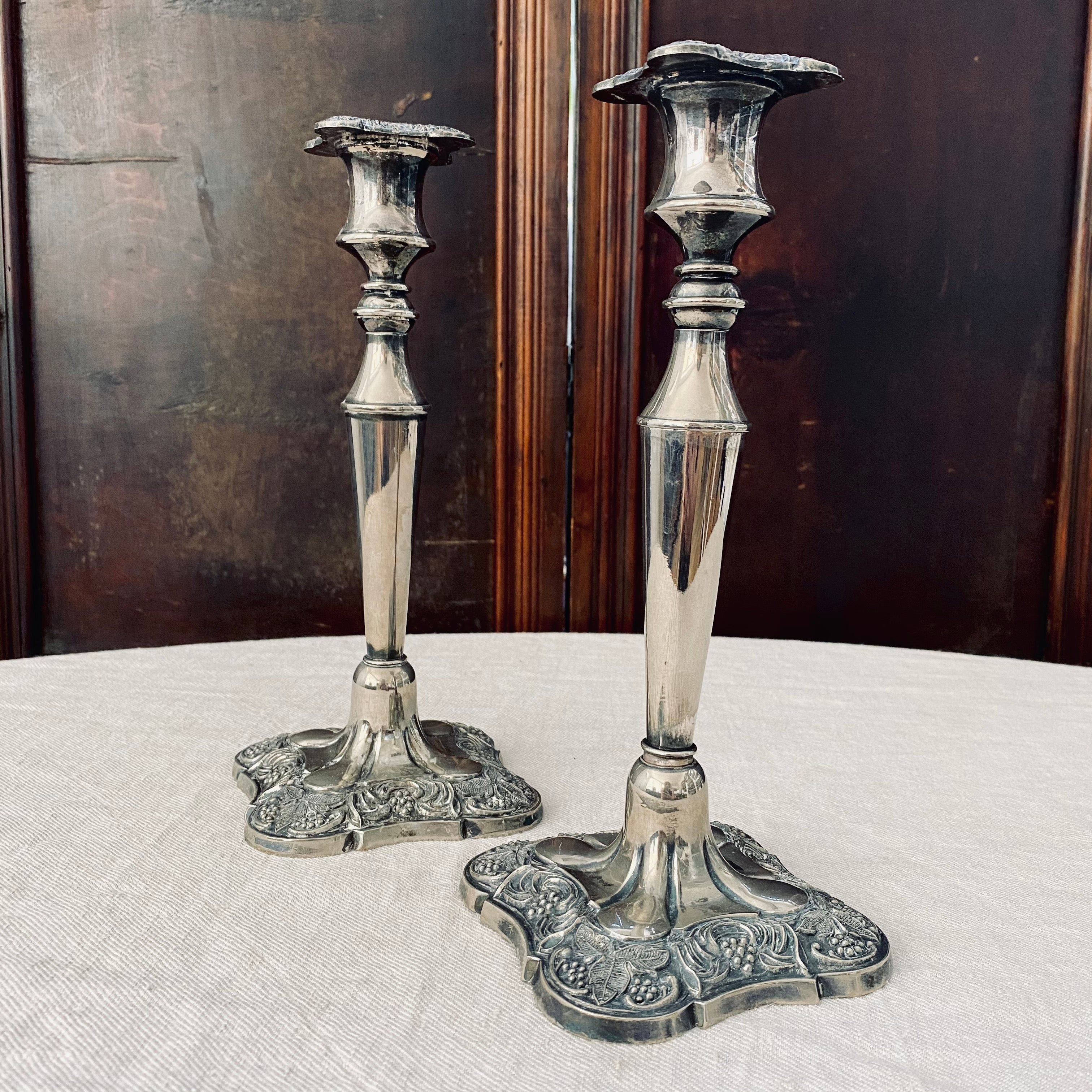 Pair of square-based silver plated candlesticks