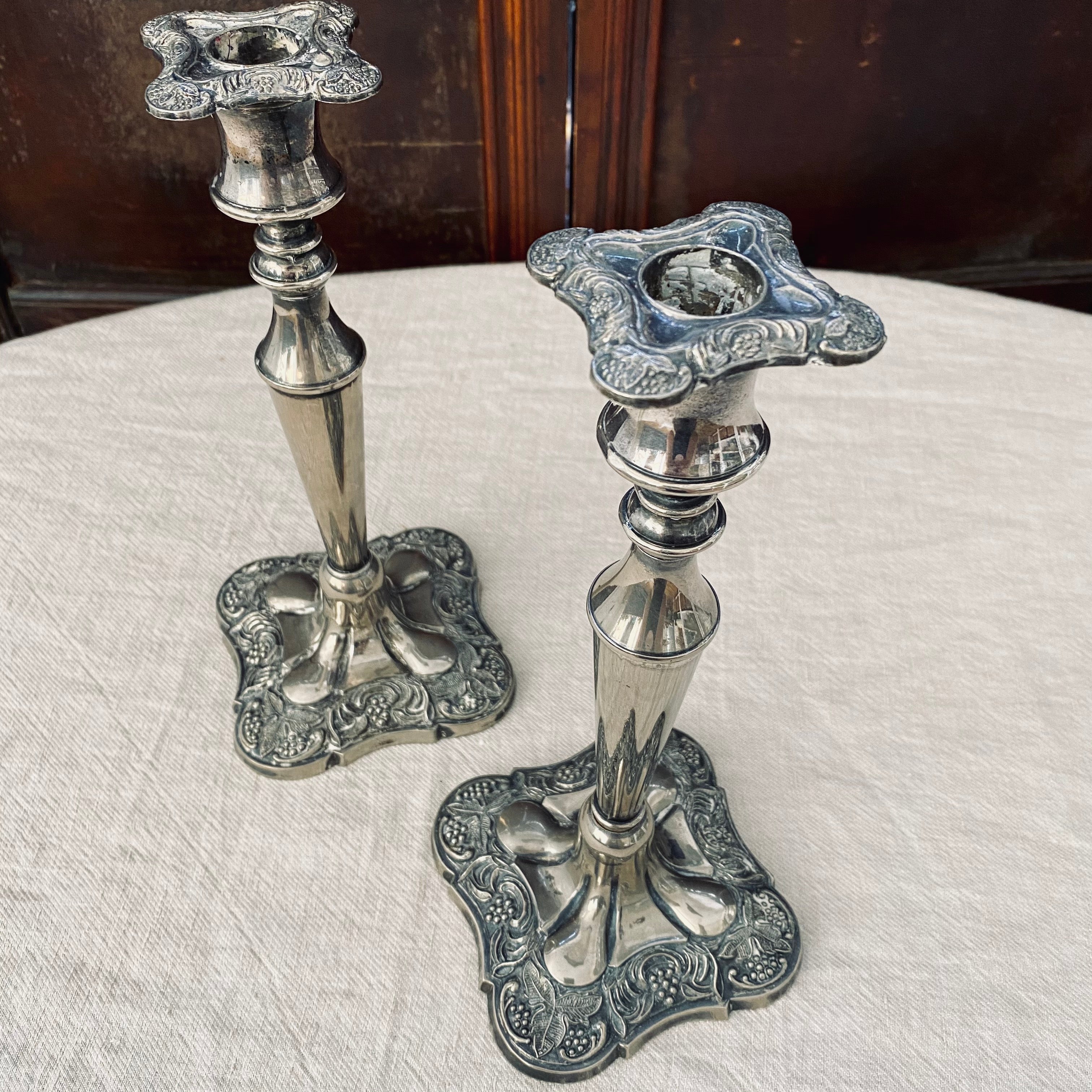 Pair of square-based silver plated candlesticks